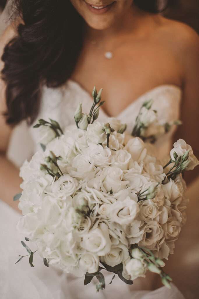 close-up detail photo of bride holding flowers