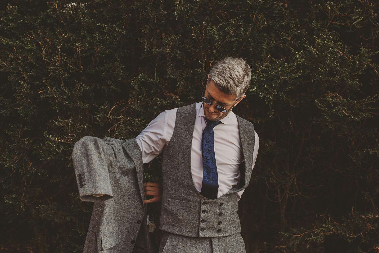 groom putting on jacket