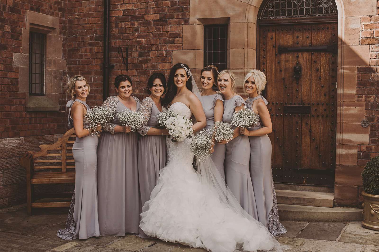 full length group photo of bridesmaids with bride outside Colshaw Hall