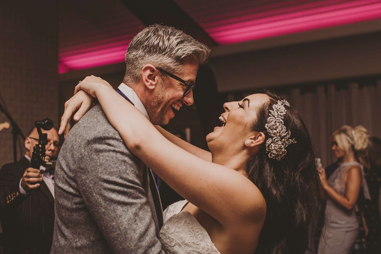 bride and groom laughing together during their evening wedding reception