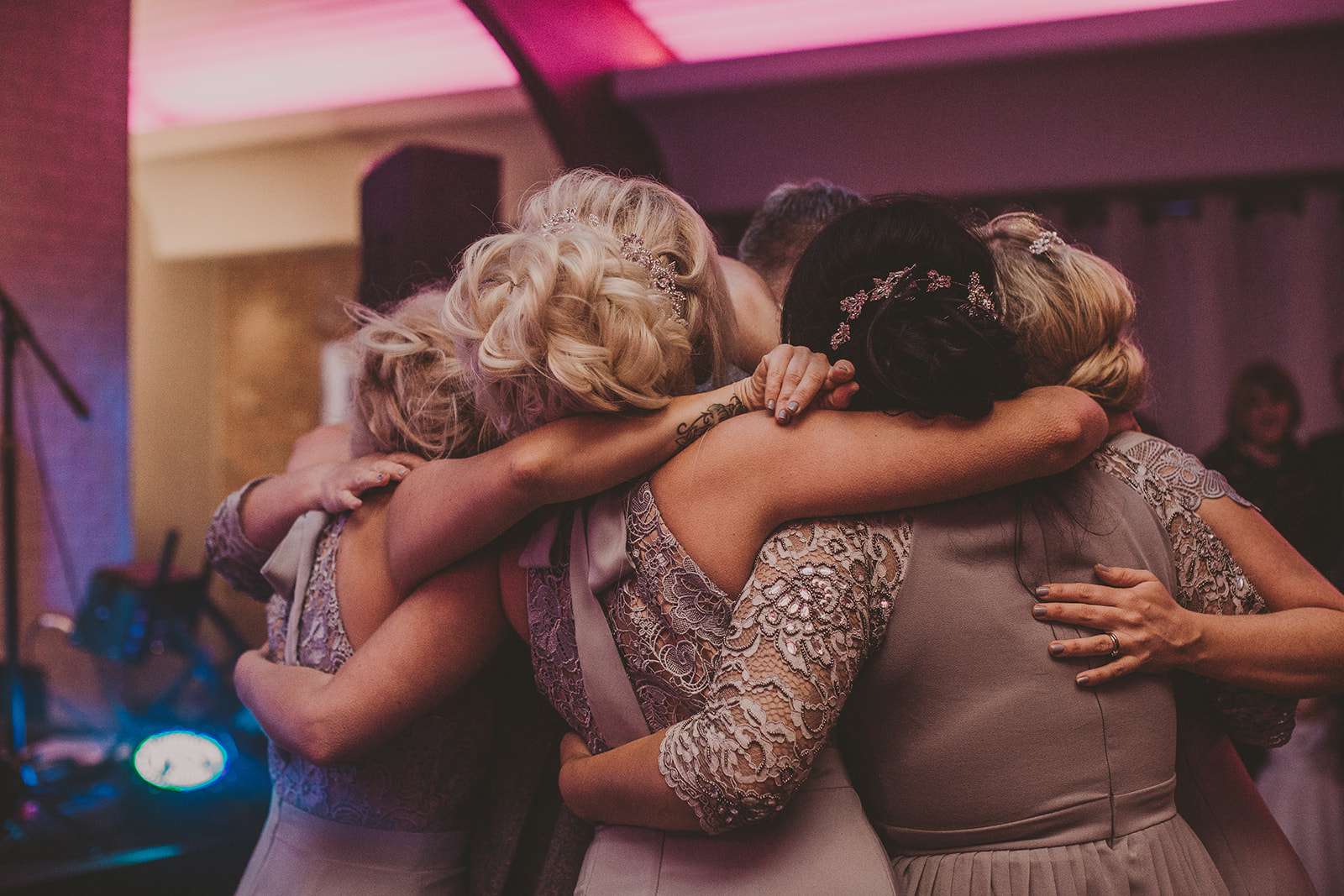 bridesmaids dance on dancefloor during the wedding reception at Colshaw Hall