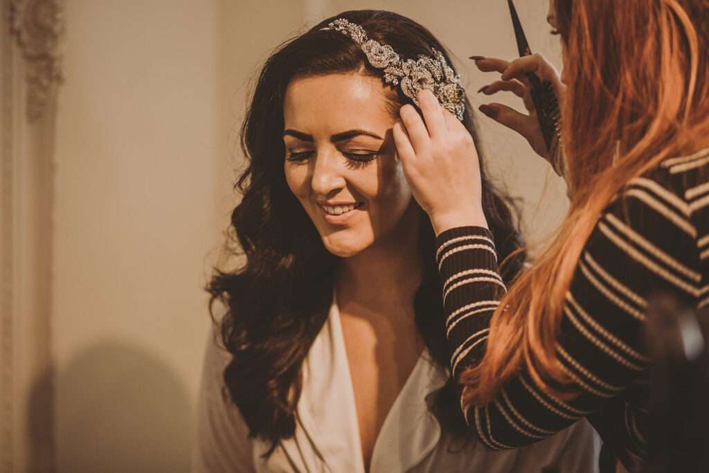 bride having hair accessory applied during bridal preparations at Colshaw Hall