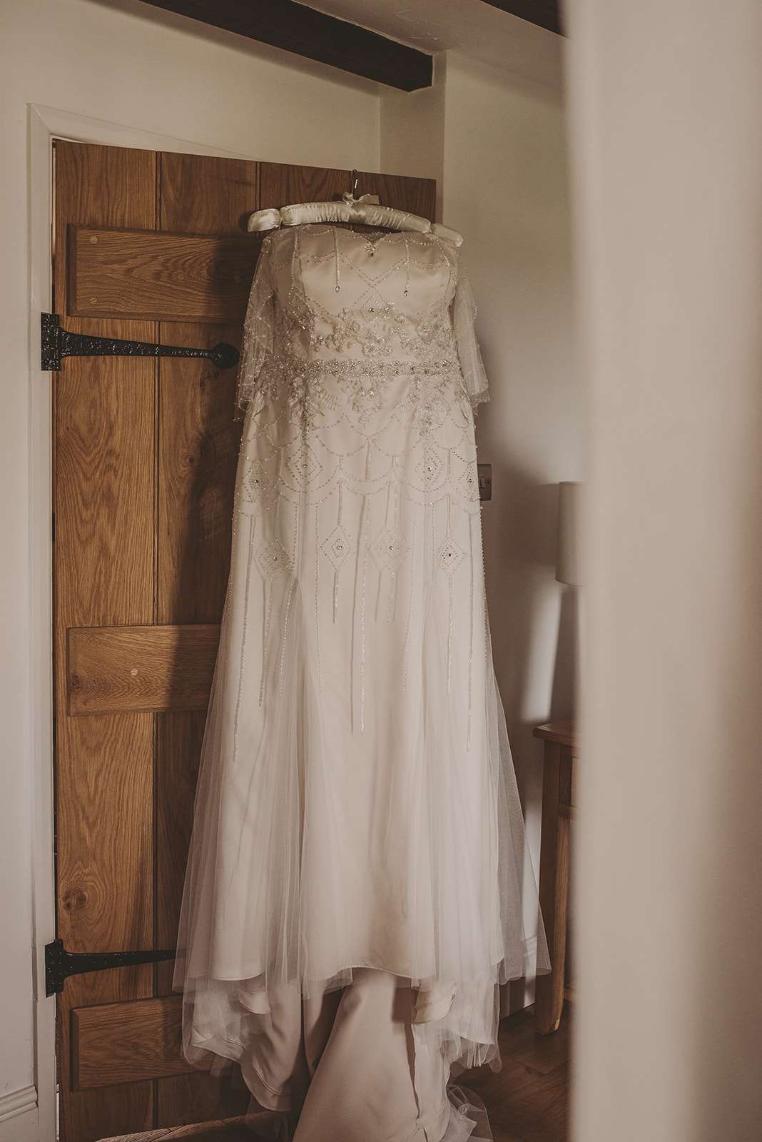 full length photo of wedding dress hanging up
