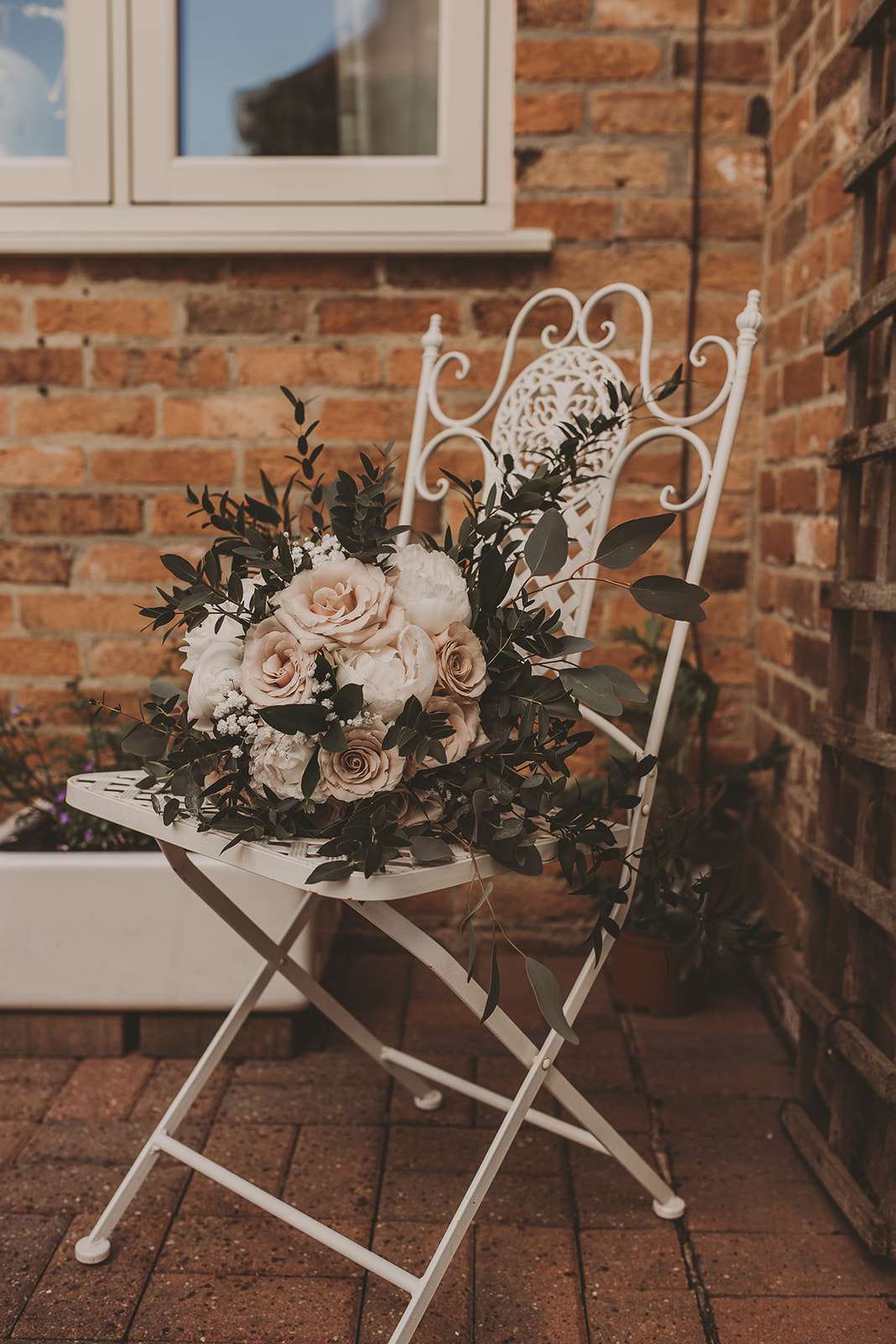 bridal bouquet on white metal chair