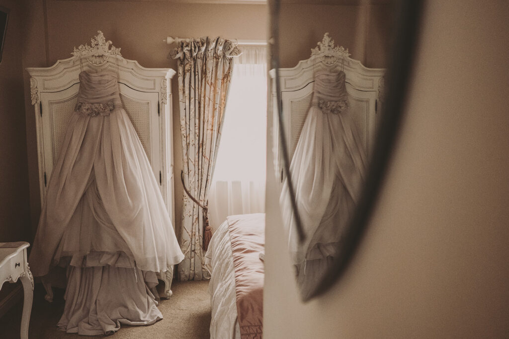 brides dress hanging up in the bridal suite at Sandhole Oak Barn