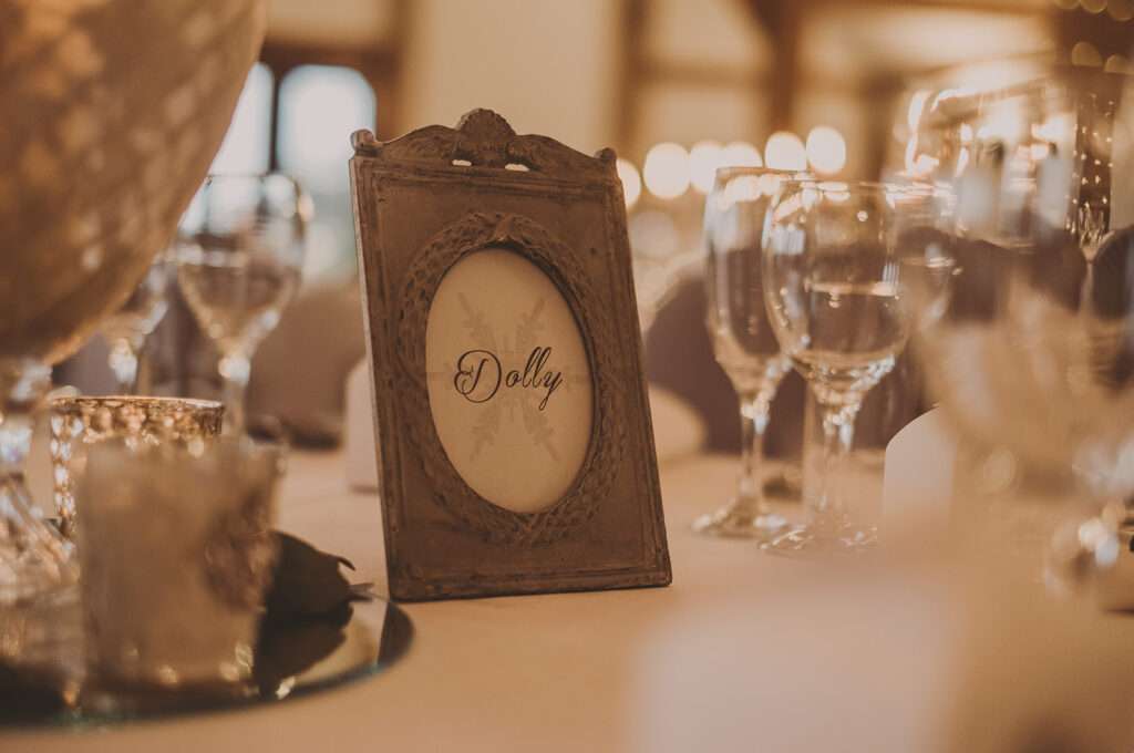 photo frame table details in the wedding breakfast room at Sandhole Oak Barn