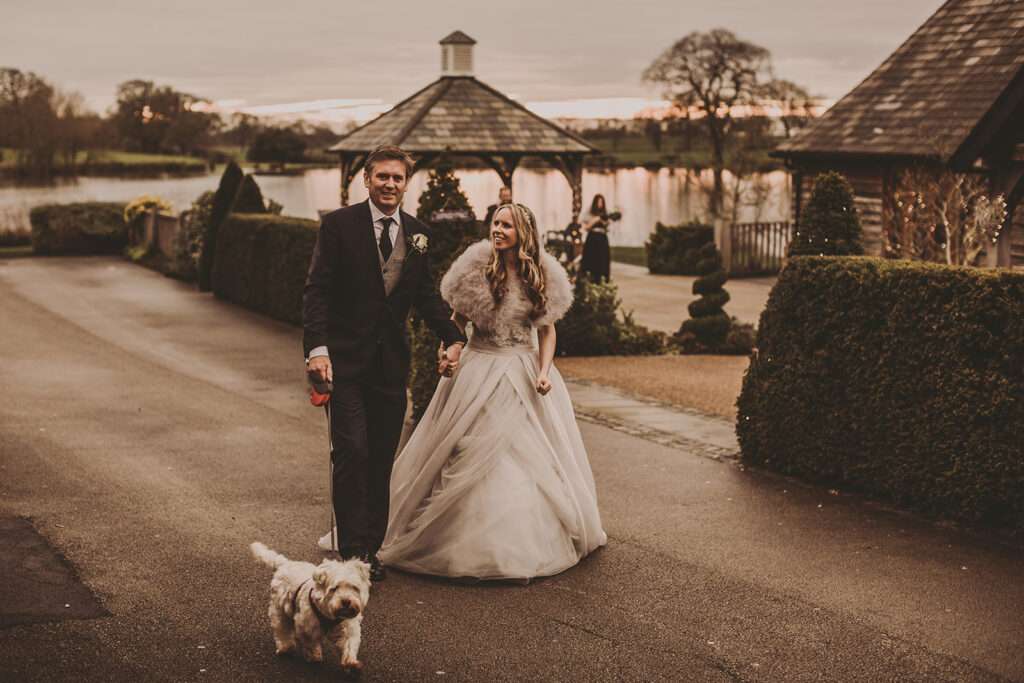 bride and groom with their dog on their wedding day at Sandhole Oak Barn