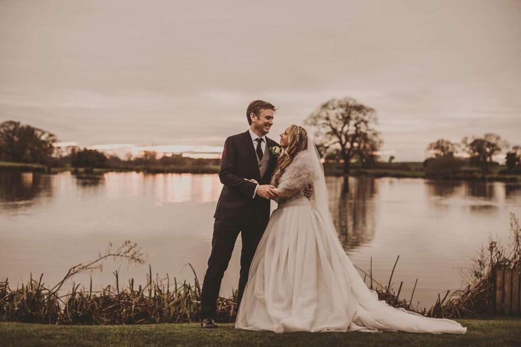 bride and groom embrace during a portrait at Sandhole Oak Barn