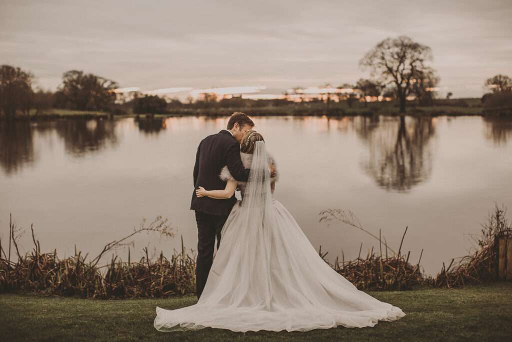 bride and groom watch sunset together on their wedding day at Sandhole Oak Barn