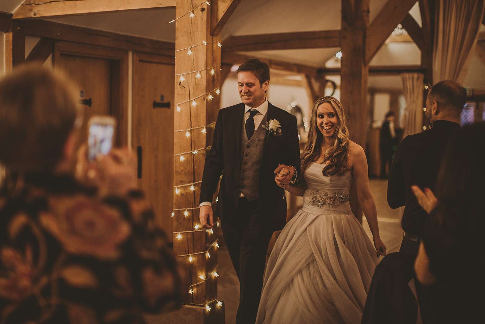 bride and groom enter wedding breakfast room