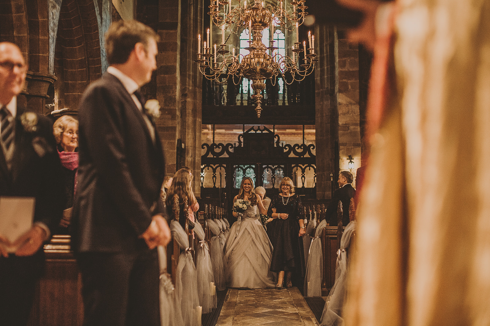 bride walks down aisle to meet her groom