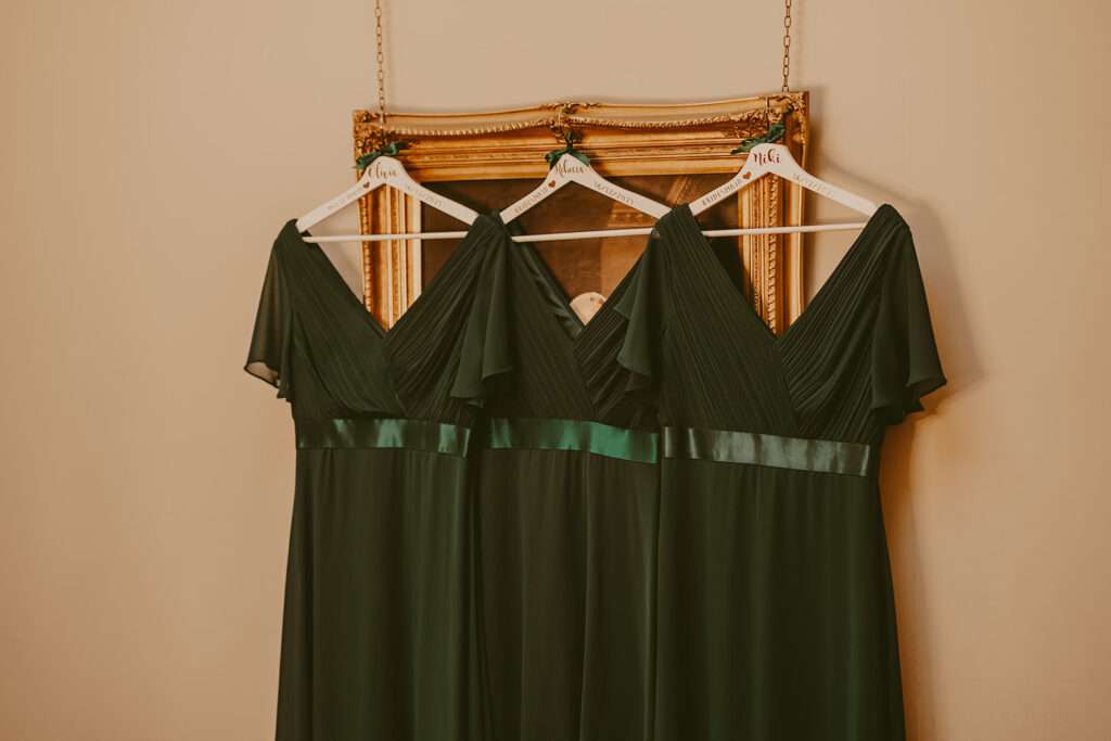 dark green bridesmaids dresses hanging up at Ashfield House