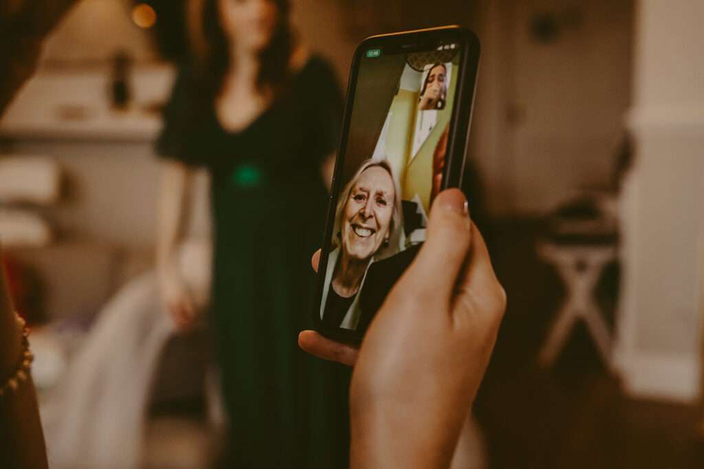 bride speaking to guests on the phone who are unable to attend the wedding