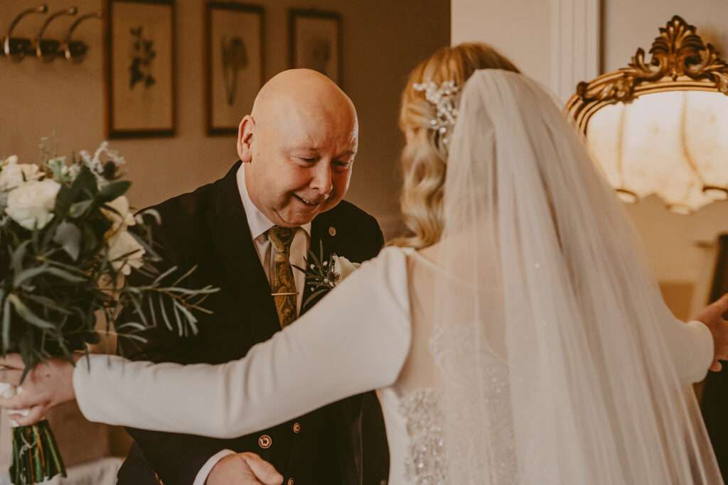 bride and her dad embrace