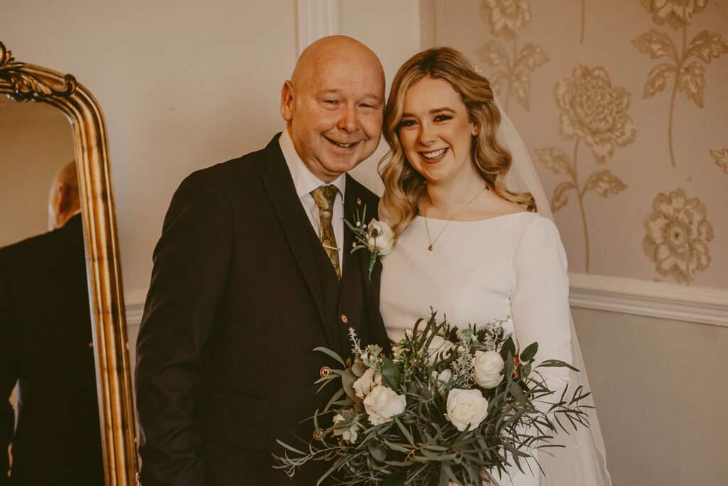 bride and her dad pose for a portrait