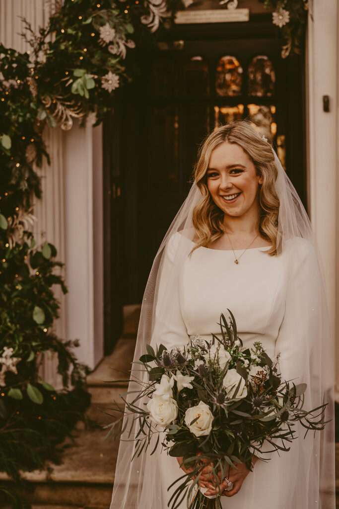 bride poses for a portrait on her wedding day at Ashfield House