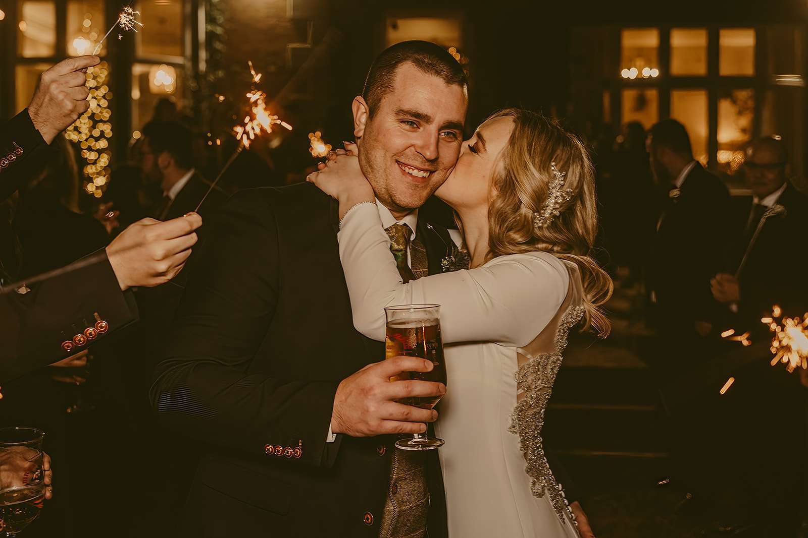 bride kisses groom during evening wedding reception